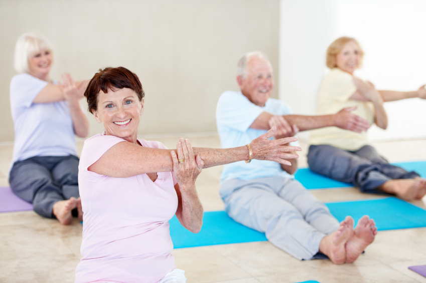 Portrait of a senior woman enjoying a yoga class with other seniors